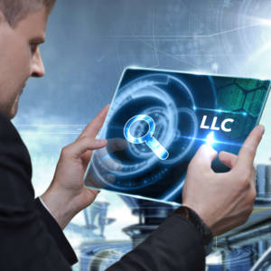 Man with LLC on computer screen