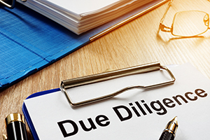 Document with title Due Diligence on a desk.