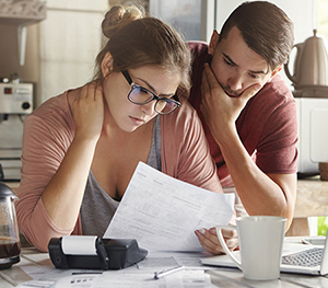 Couple looking at computer and finances and documents