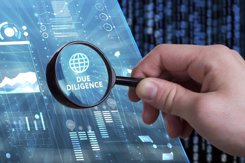 Due Diligence on computer screen under magnifying glass