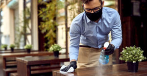guy polishing table with plant