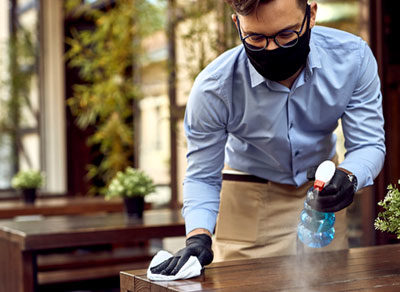 guy polishing table with plant