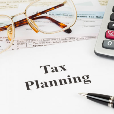 Tax planning wirh calculator and glasses taxation concept