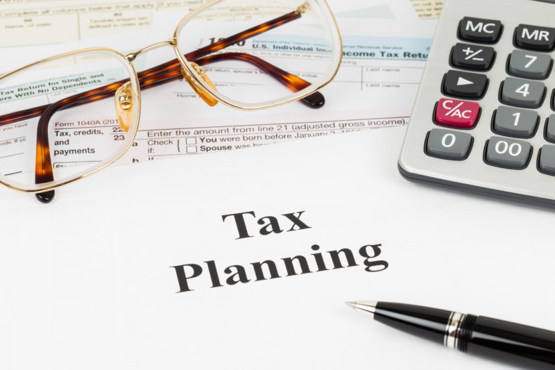 Tax planning wirh calculator and glasses taxation concept