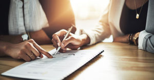 Two People Checking Companys Audited Financial Statements