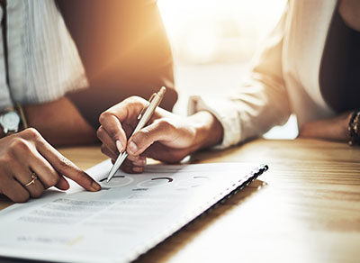 Two People Checking Companys Audited Financial Statements