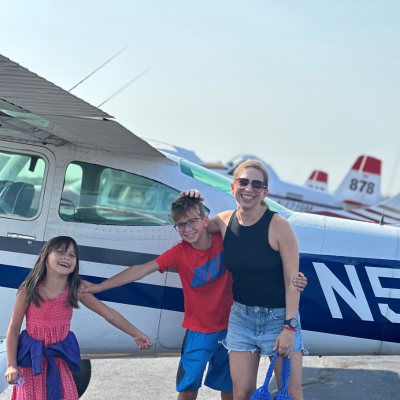 Michelle Kopplow with her children and a private plane